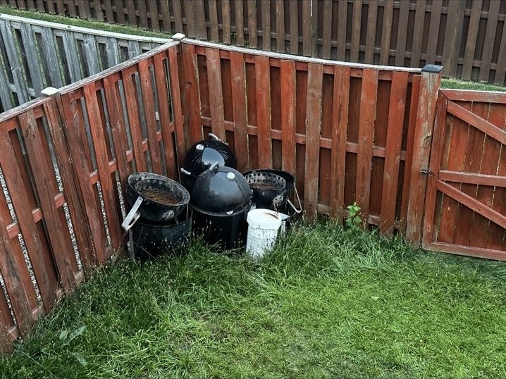Backyard before several unwanted grills and containers were removed